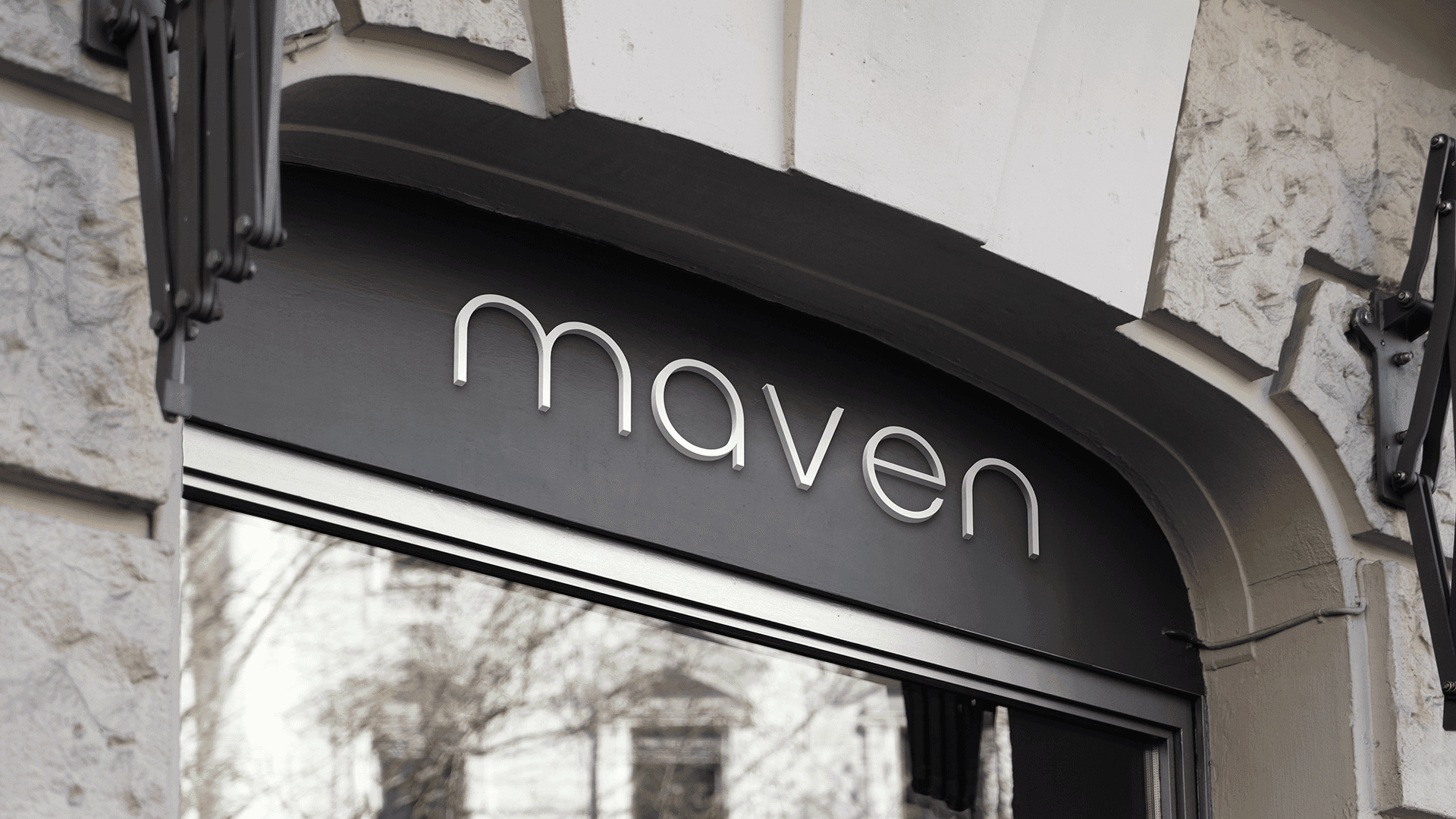 The Maven wordmark on a black storefront sign